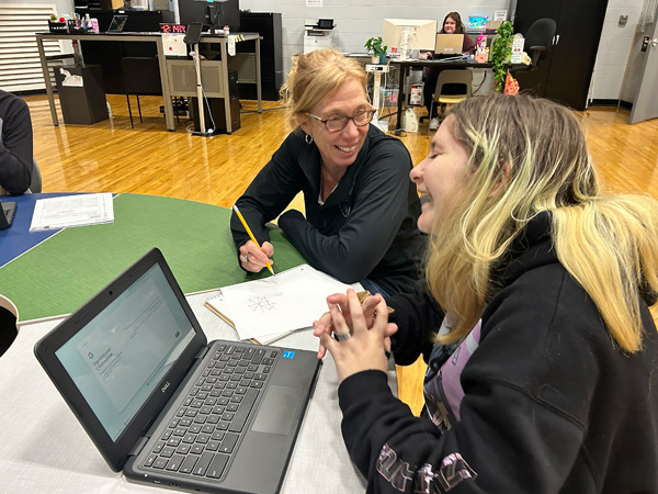ms. jen works with a student to learn math skills at west michigan virtual academy